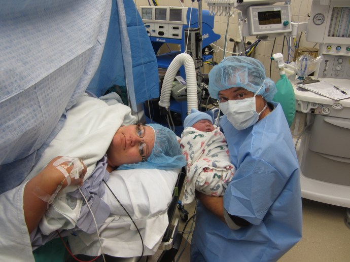 Here he is holding Kirby while I am still being sewn up...